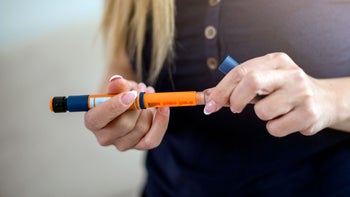 NovoLog: closeup woman holding insulin pen 1136060062