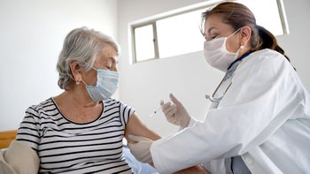 Health: Medicare: senior woman getting COVID shot-1278870086