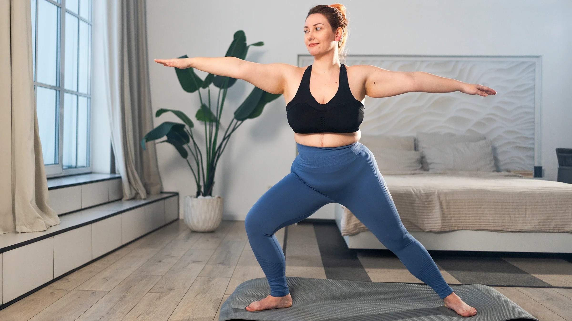 Woman practicing yoga at home
