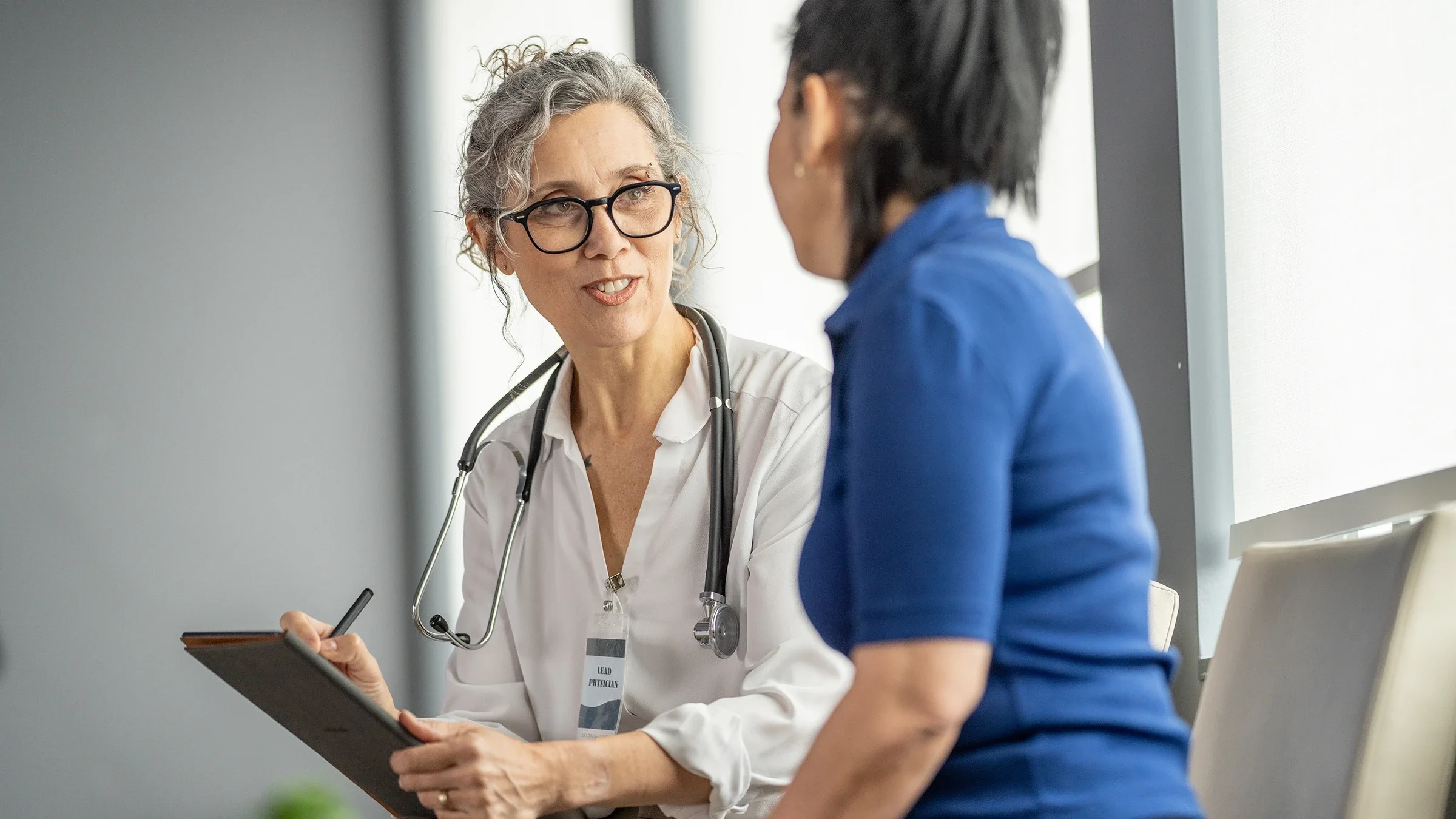 A medical practitioner is discussing healthcare concerns with a patient.
