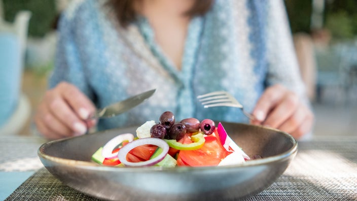 Diet nutrition: Nightshade: close up woman eating salad-1403121544