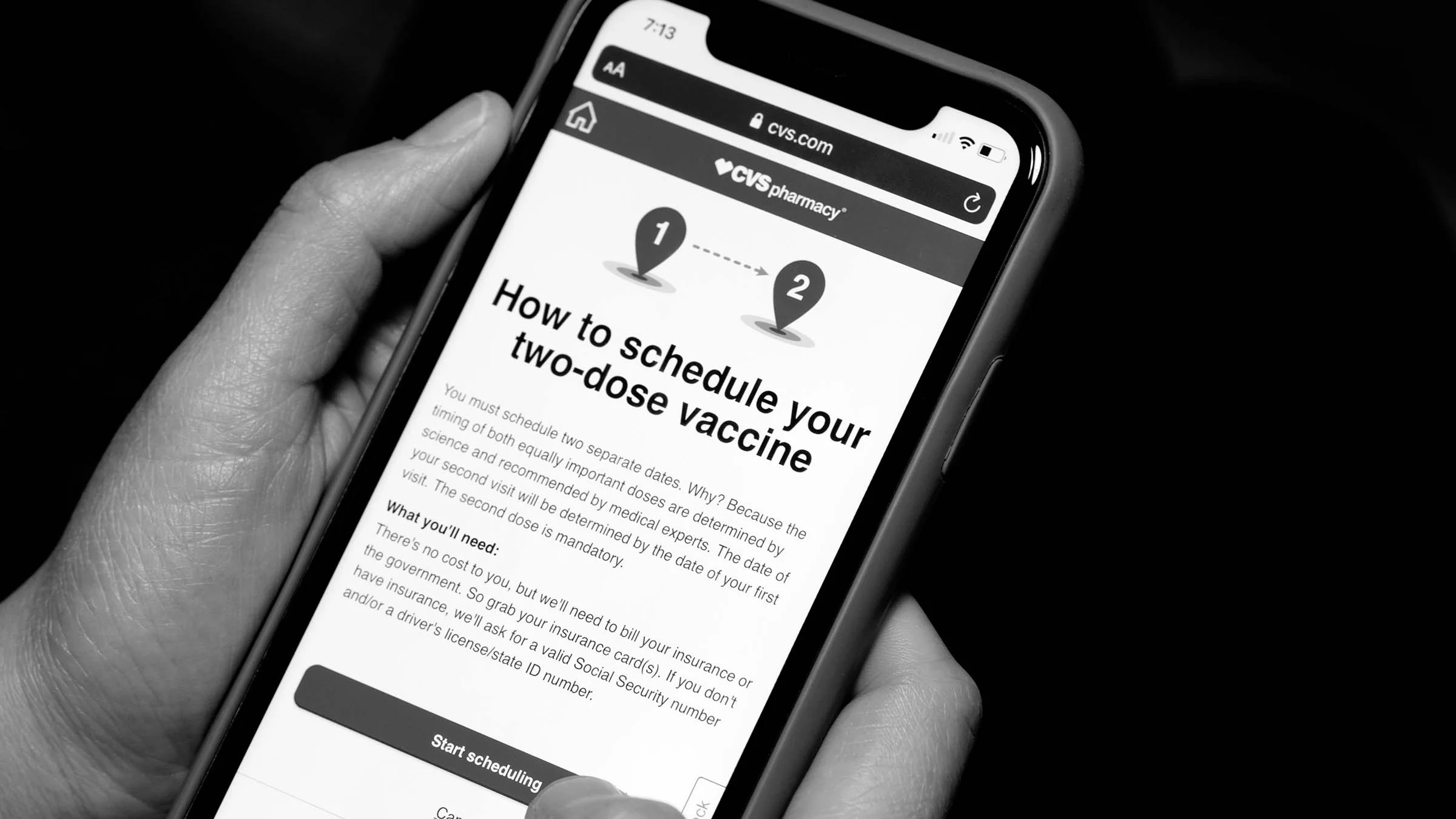Close-up of a person using their mobile phone to schedule a second vaccine at CVS Pharmacy.