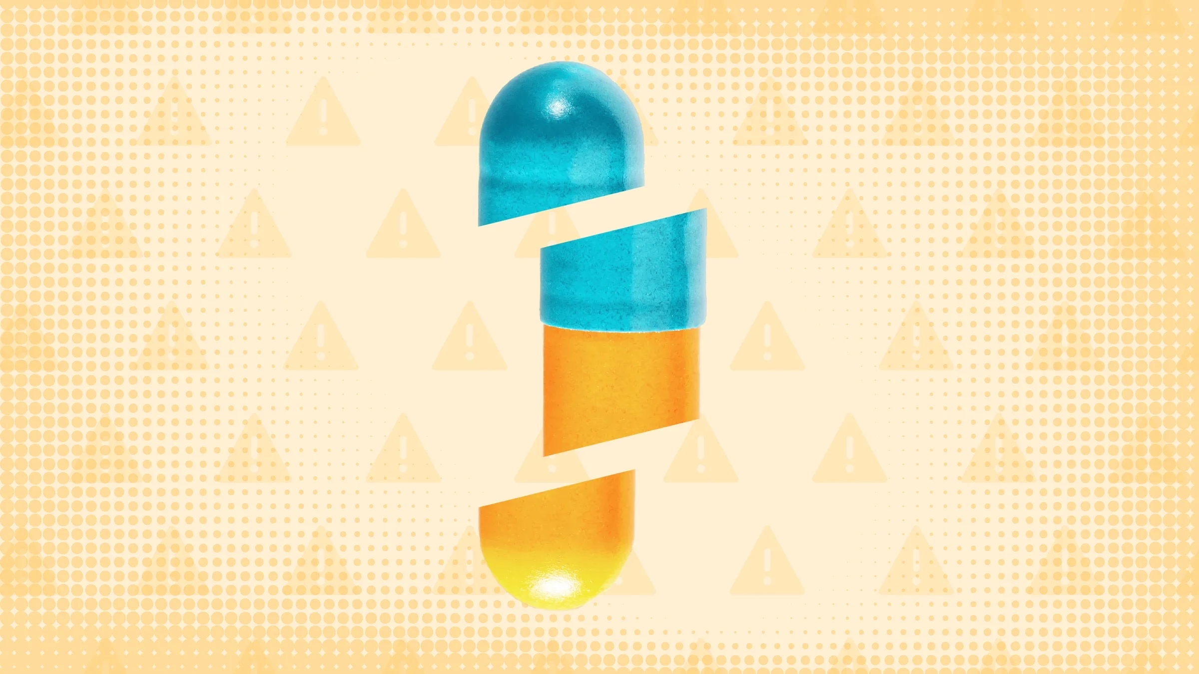Light-orange background with texture and warning sign pattern. In the center is an orange-and-blue capsule pill cut into thirds.  
GoodRx Health
