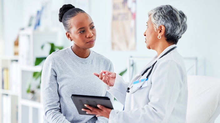 A doctor talks with a woman about lymphoma.