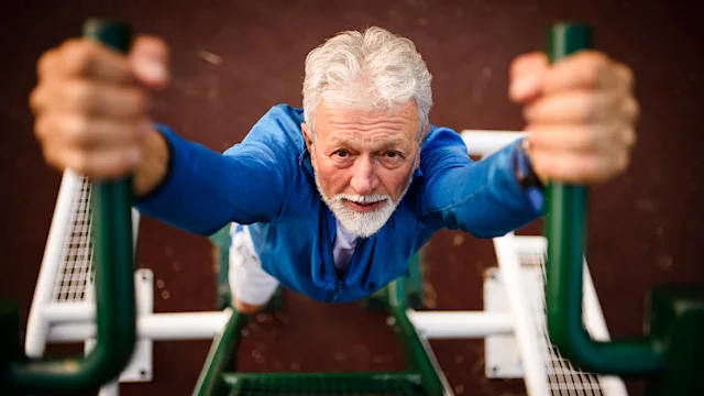 Movement-exercise: senior man doing pull up 1031518492