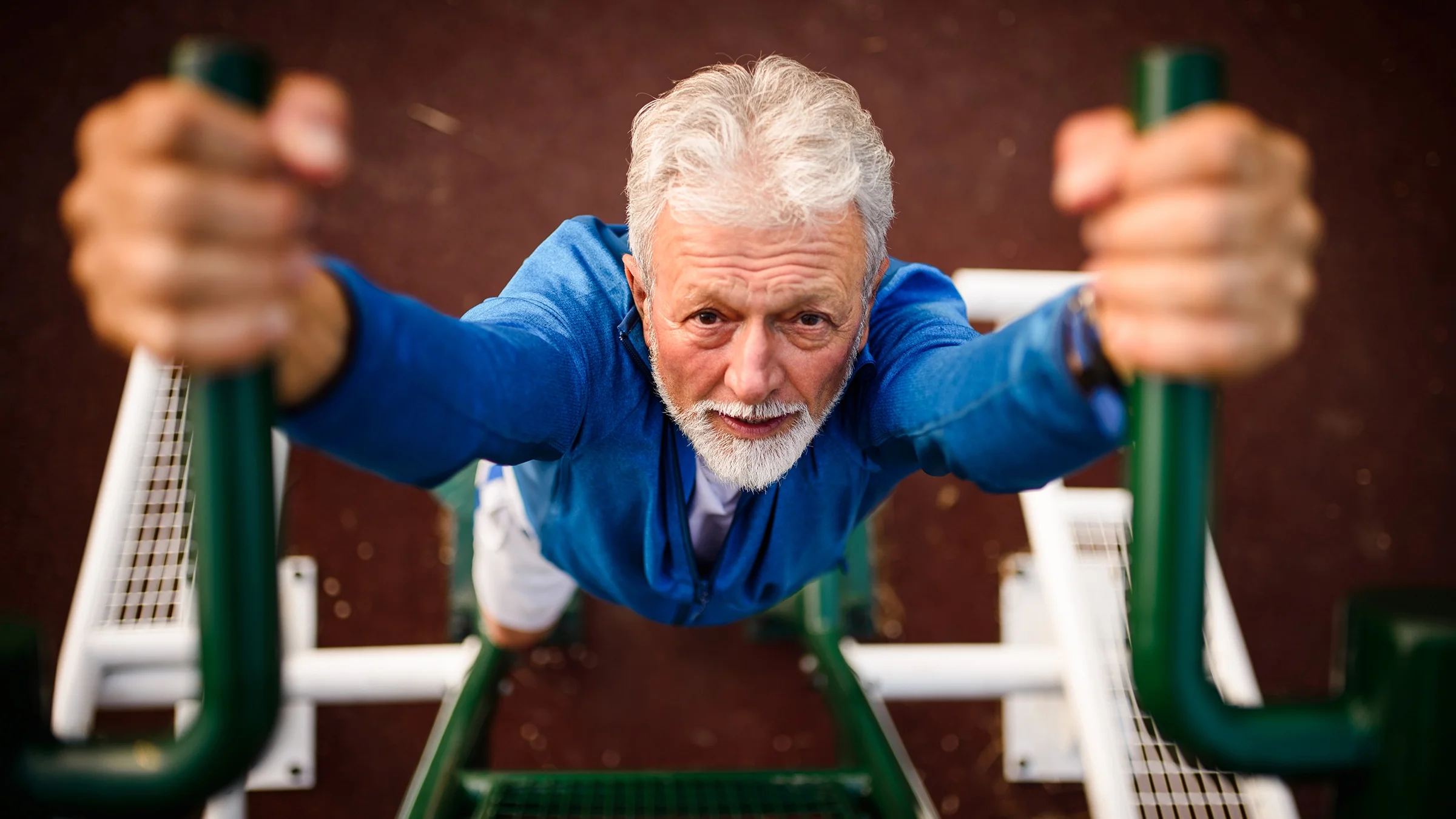 An older man doing a pull up.