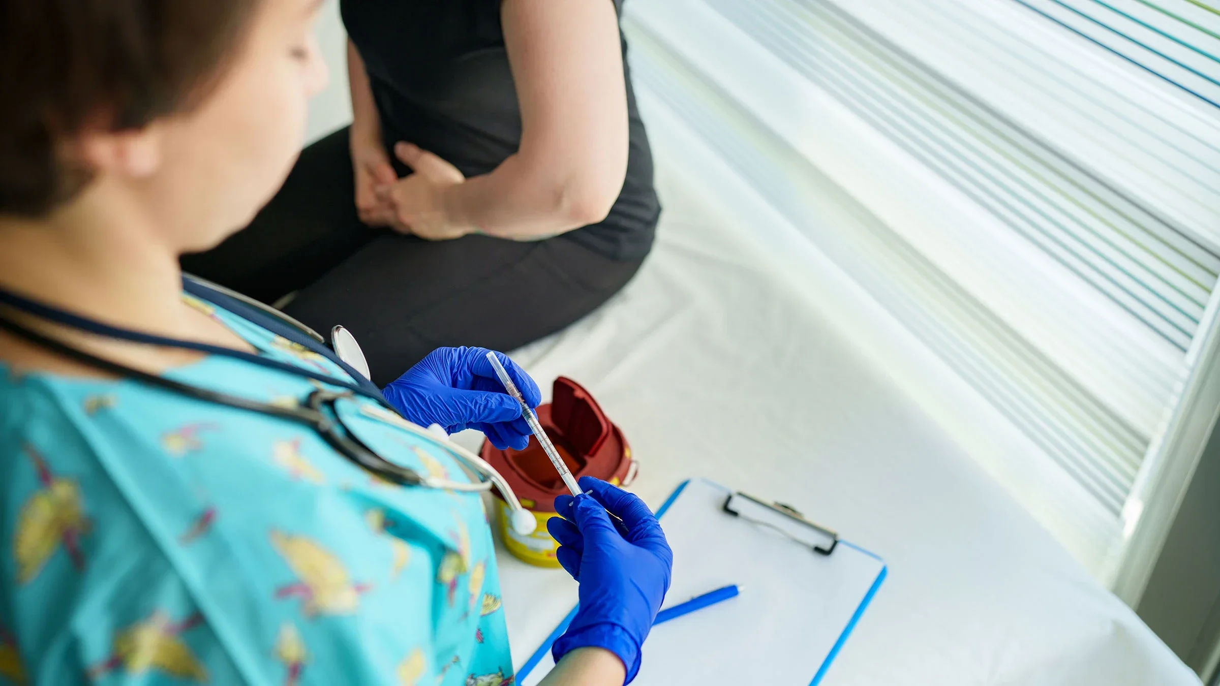 Close-up of a nurse holding a vaccine syringe.
Ugur Karakoc/E+ via Getty Images