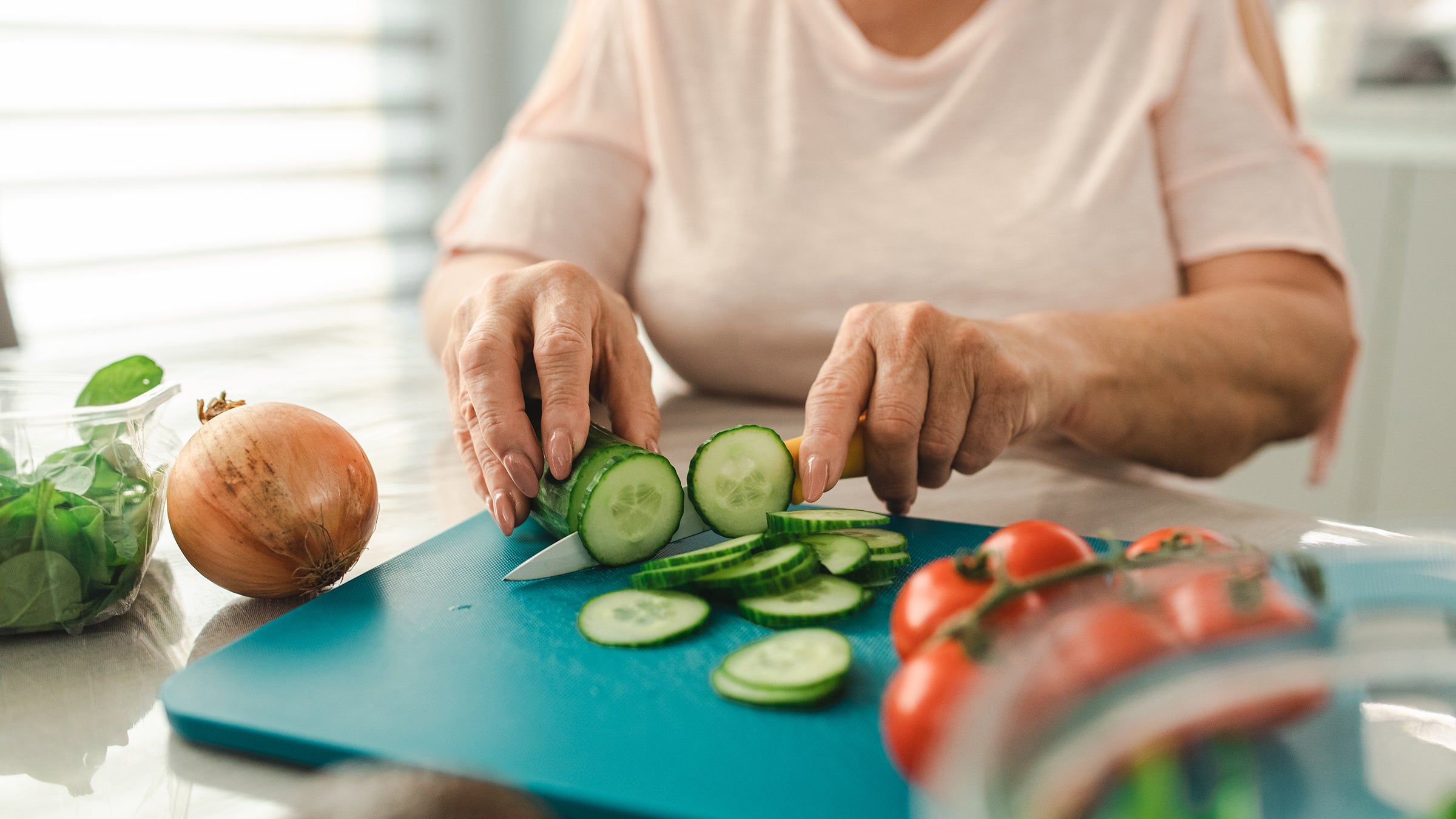 Diet and nutrition: closeup cutting cucumbers 1412478473