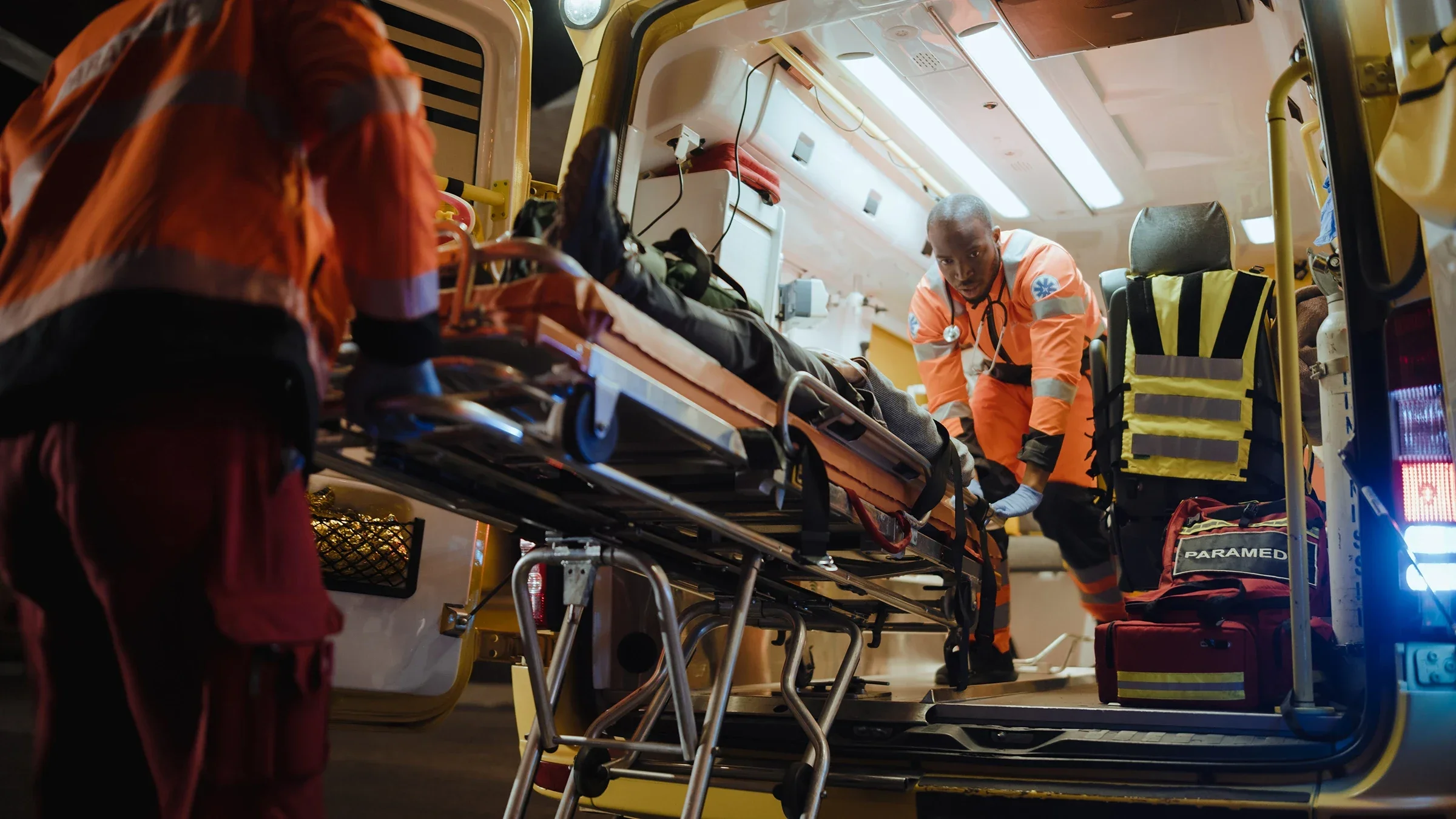 EMTs loading a person into an ambulance.
gorodenkoff/iStock via Getty Images