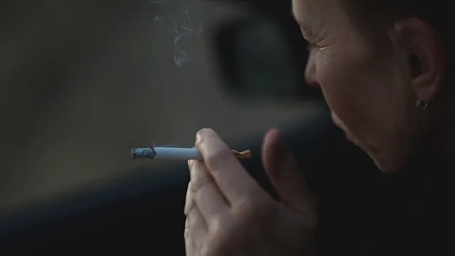 glp-1-agonists: closeup hand holding a cigarette 1447094869