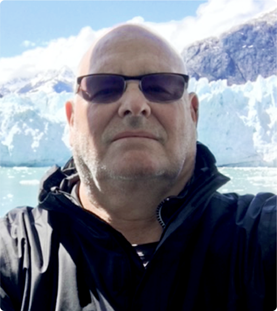 This is a headshot of Brian Grover, outdoors.