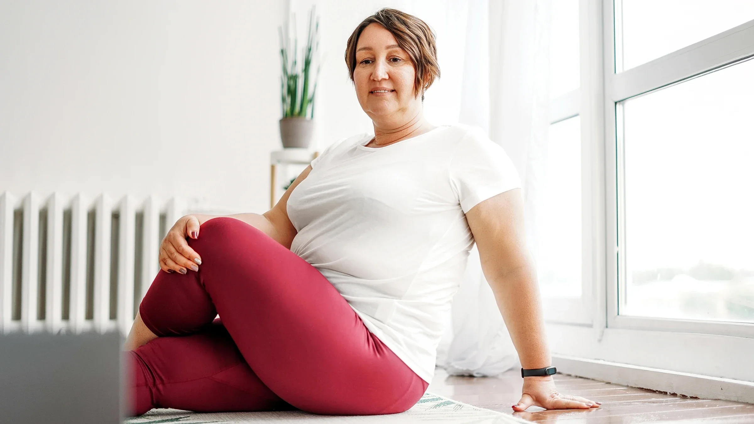 Woman practicing yoga at home via instruction on a laptop.
Galina Zhigalova/iStock via Getty Images Plus