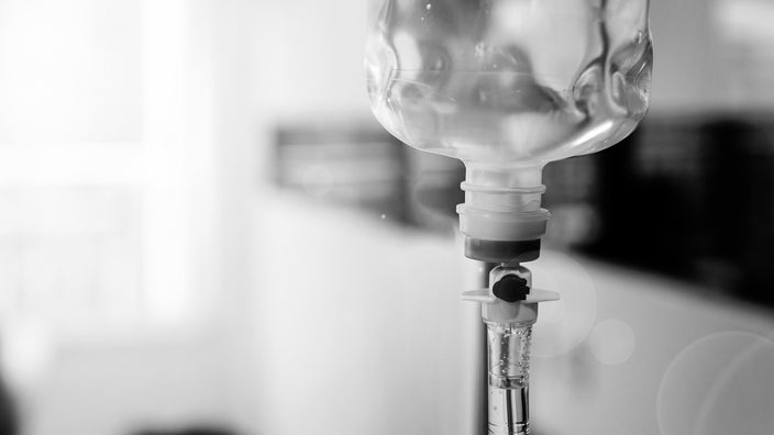 Black and white close-up of an IV bag.