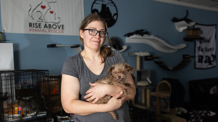 Portrait of Kaitlin Langlois with her special-needs dog Baby Puppy at Rise Above Animal Rescue in Pasadena, Maryland.
