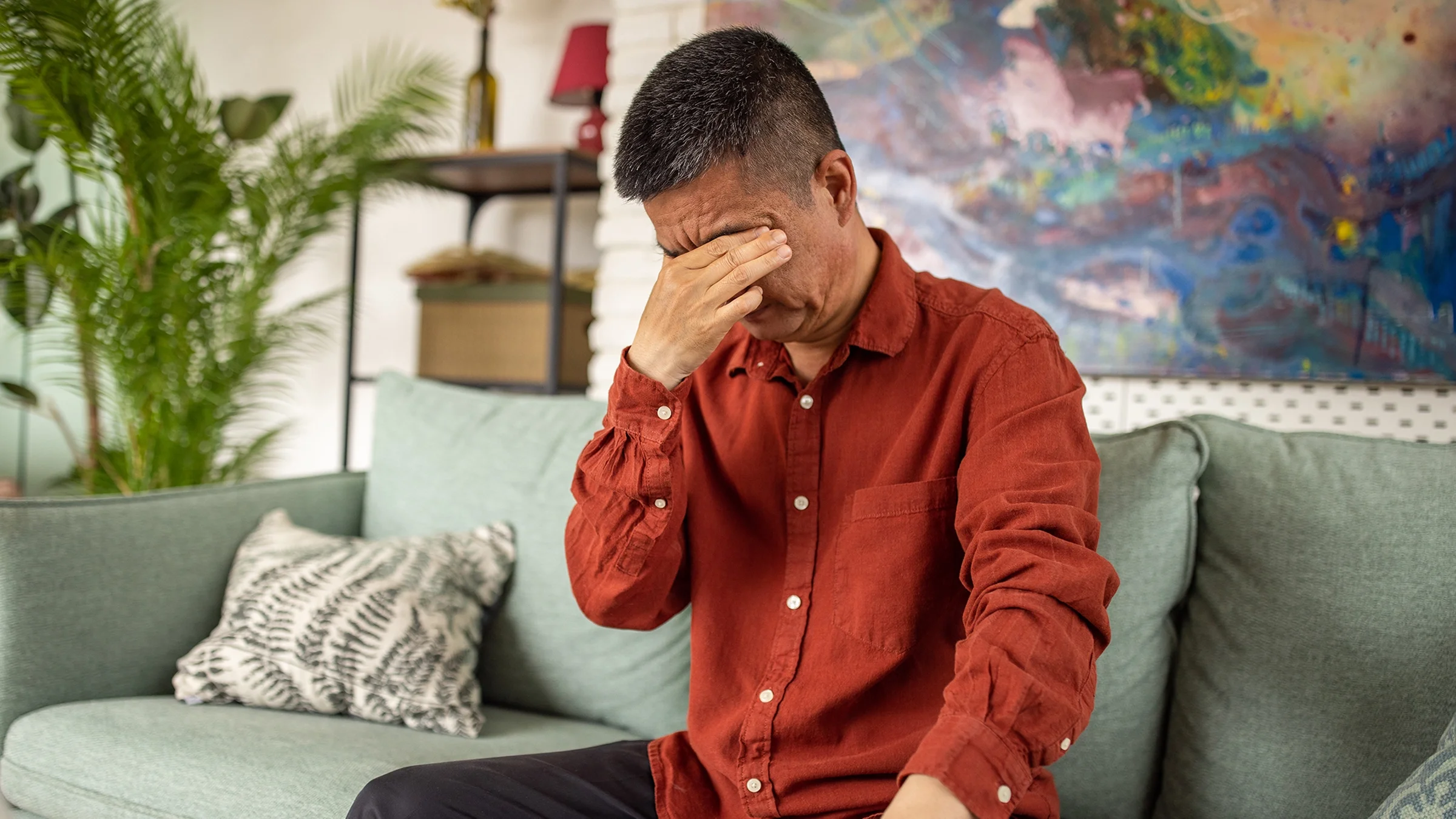 Man feeling fatigued and rubbing his eyes