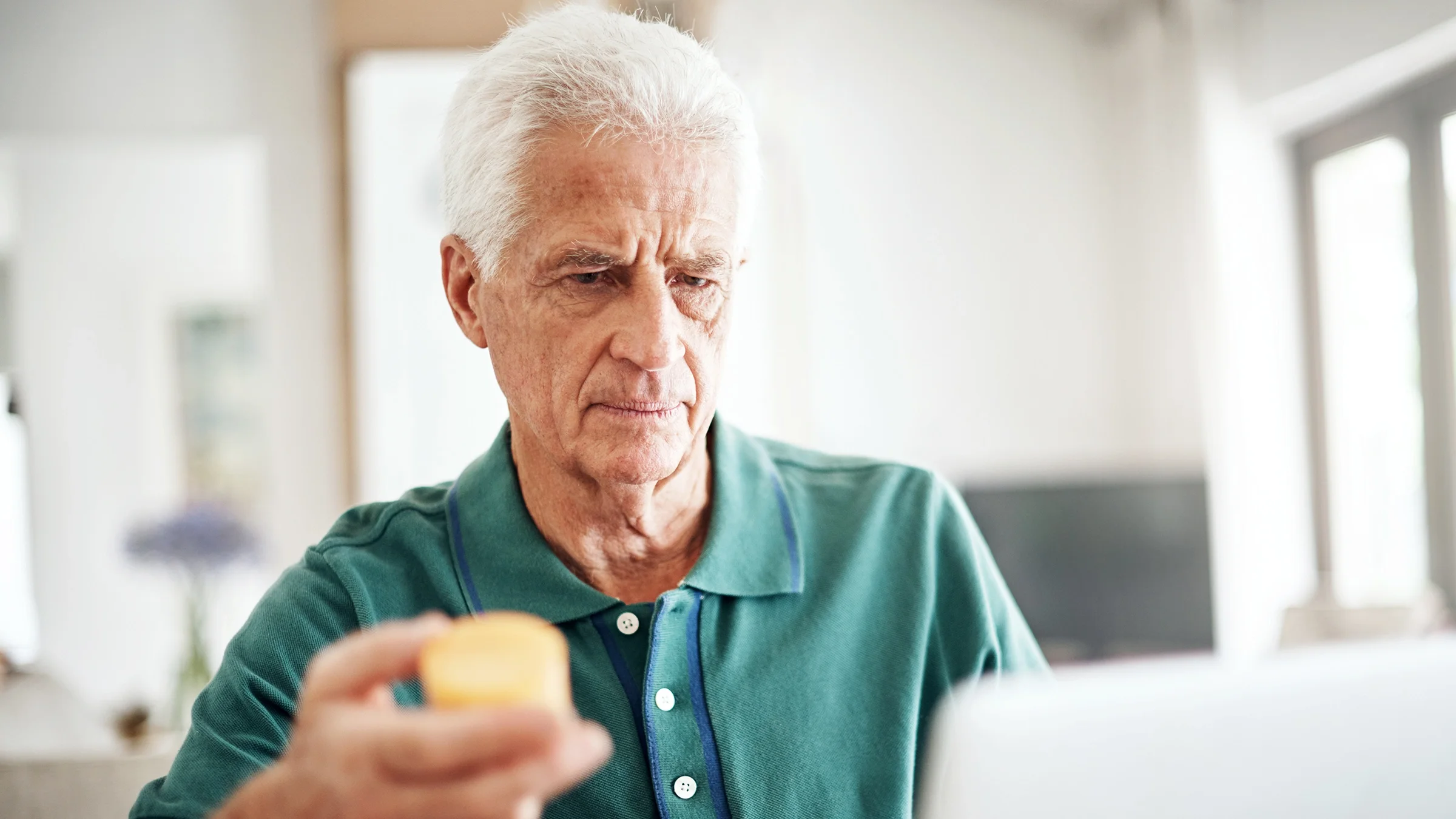 A senior man checks a prescription online.