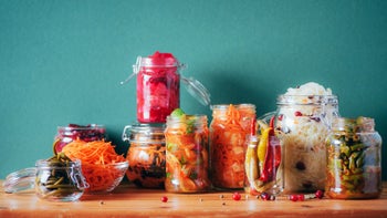 diet nutrition: jars of fermented food on wooden countertop 1190656404