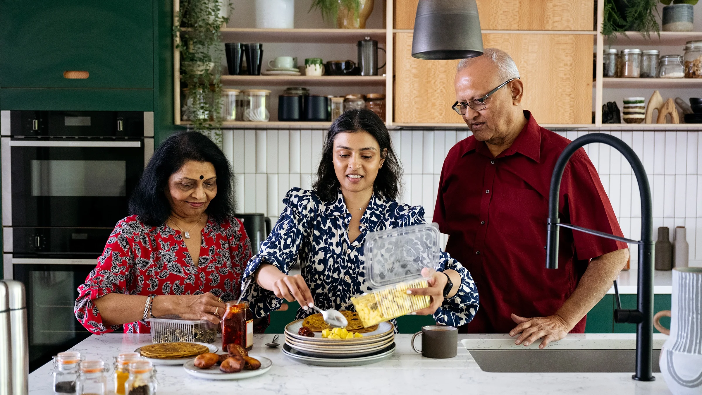Daughter preparing a meal for her parents