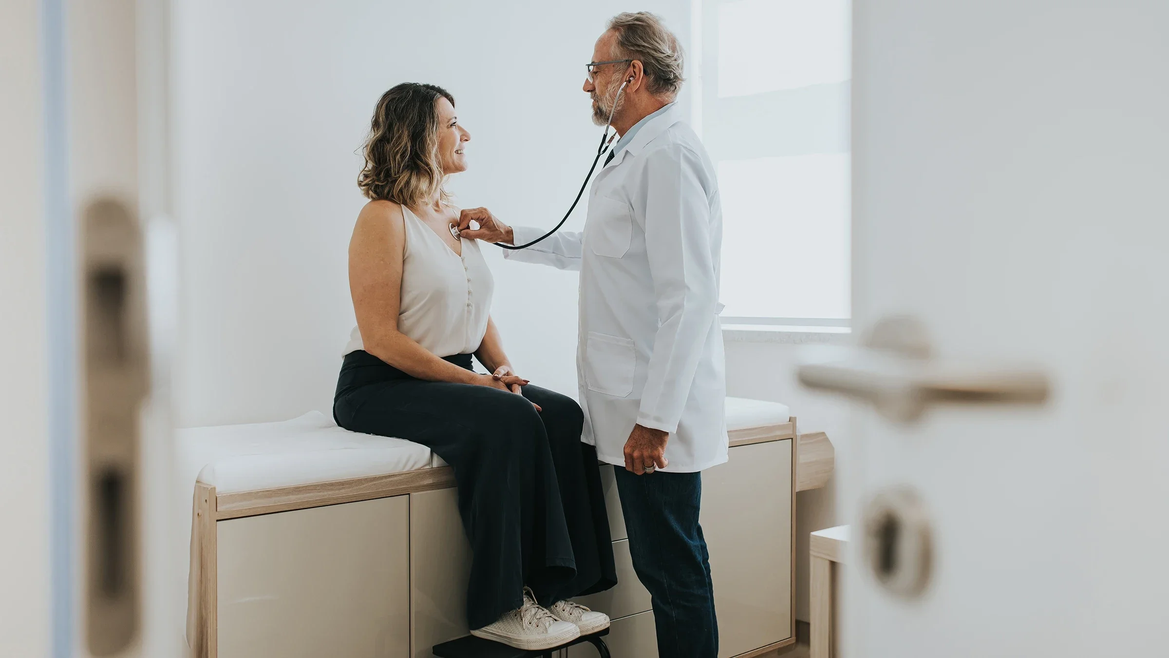 A healthcare professional is listening to a patient's heart with a stethoscope.
andreswd/E+ via Getty Images