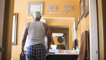 Overactive bladder: Myrbetriq and oxybtynin: senior man getting ready in bathroom mirror-937617982