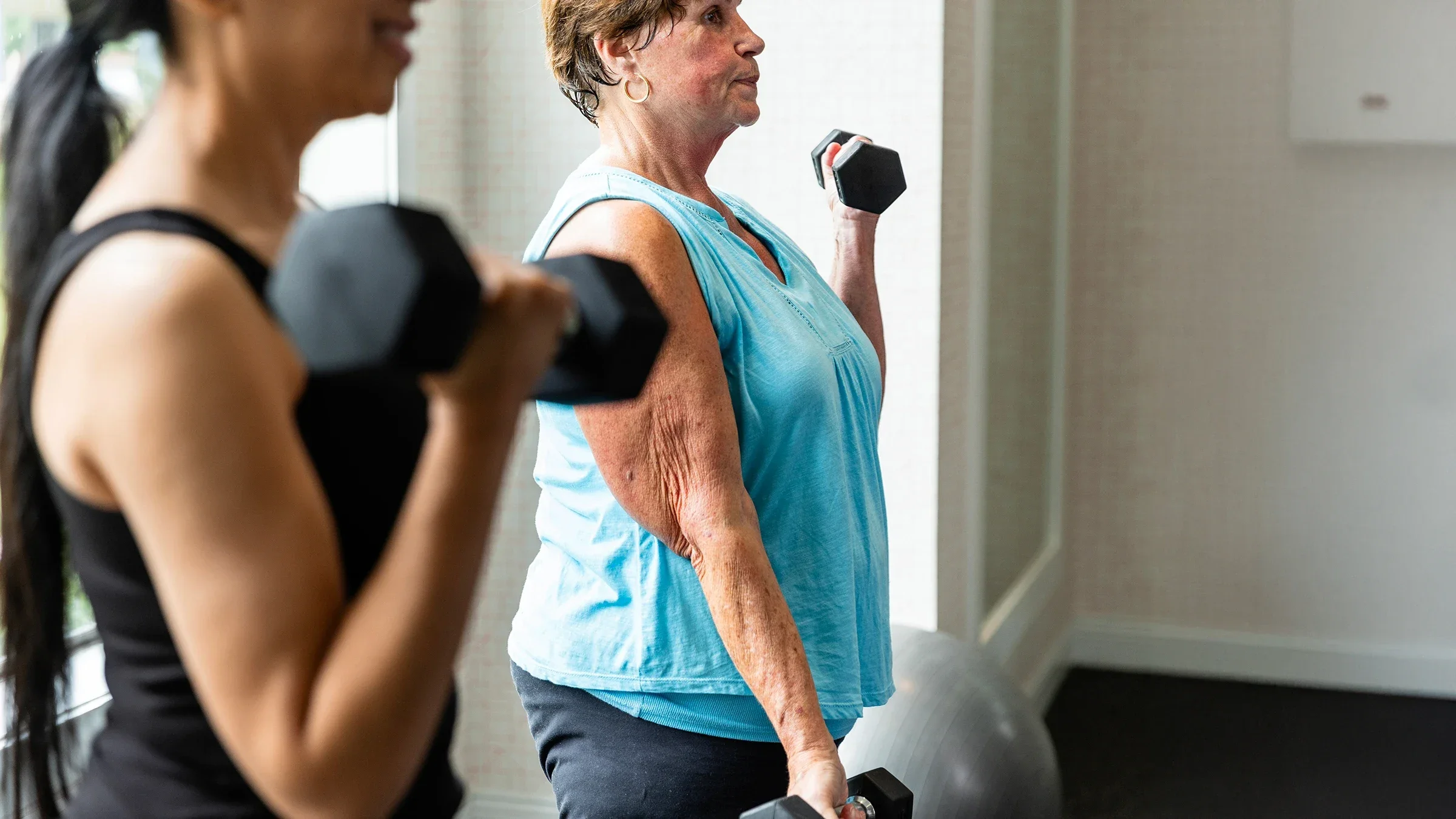Women working out together in the gym with dumbbells.
SDI Productions/E+ via Getty Images
