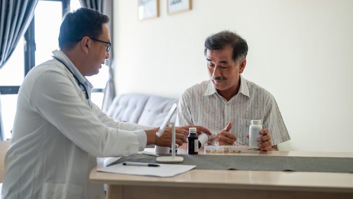 Doctor giving a senior man a medicine consultation.