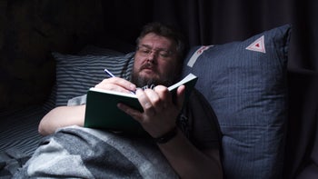 Health: Sleep: man writing in a journal 1320934448
