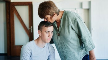 substance-use-disorder: mother supporting son kissing head-1335189503