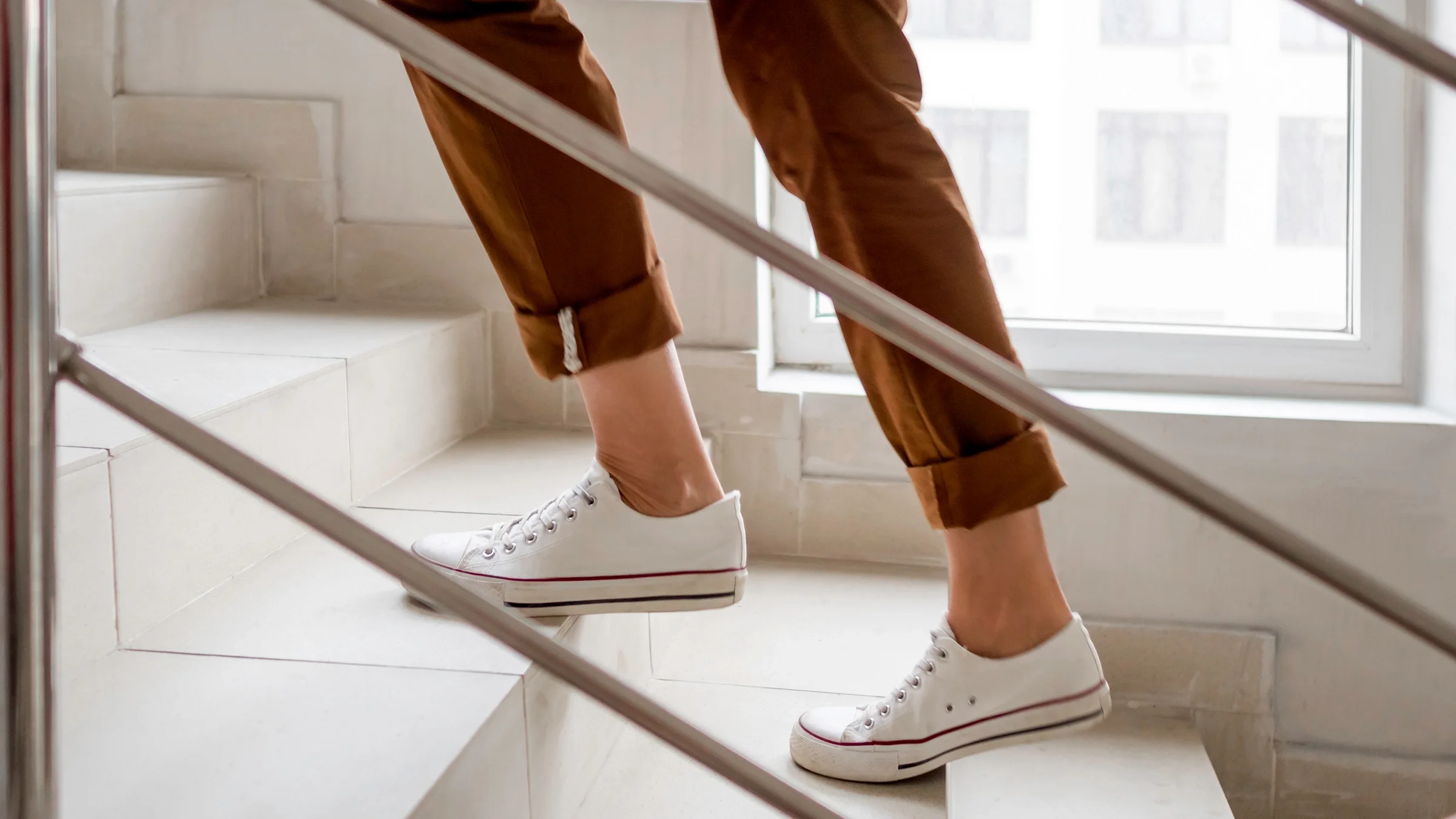 Close-up woman walking up stairs 