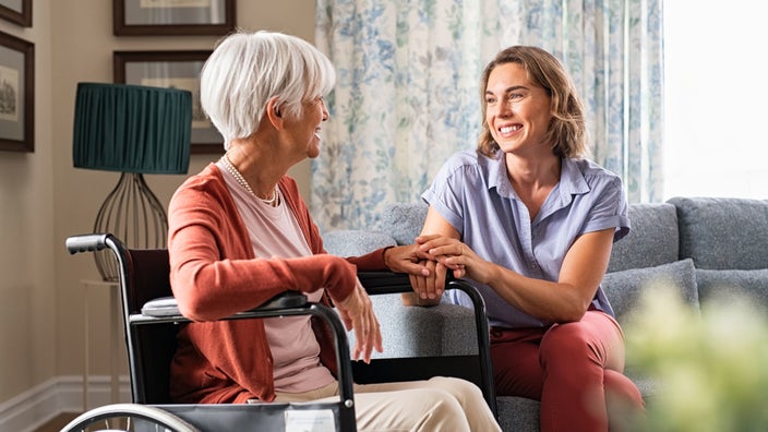 Senior woman at nursing home with family member.