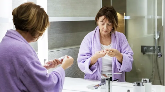 Health: Estradiol: woman reading instructions in bathroom 1475373320