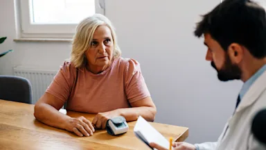 Senior woman speaking to a doctor in an office.
Sneksy/E+ via Getty Images"