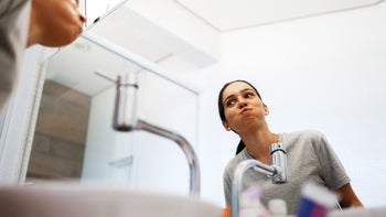 Dental care: woman gargling 851960122