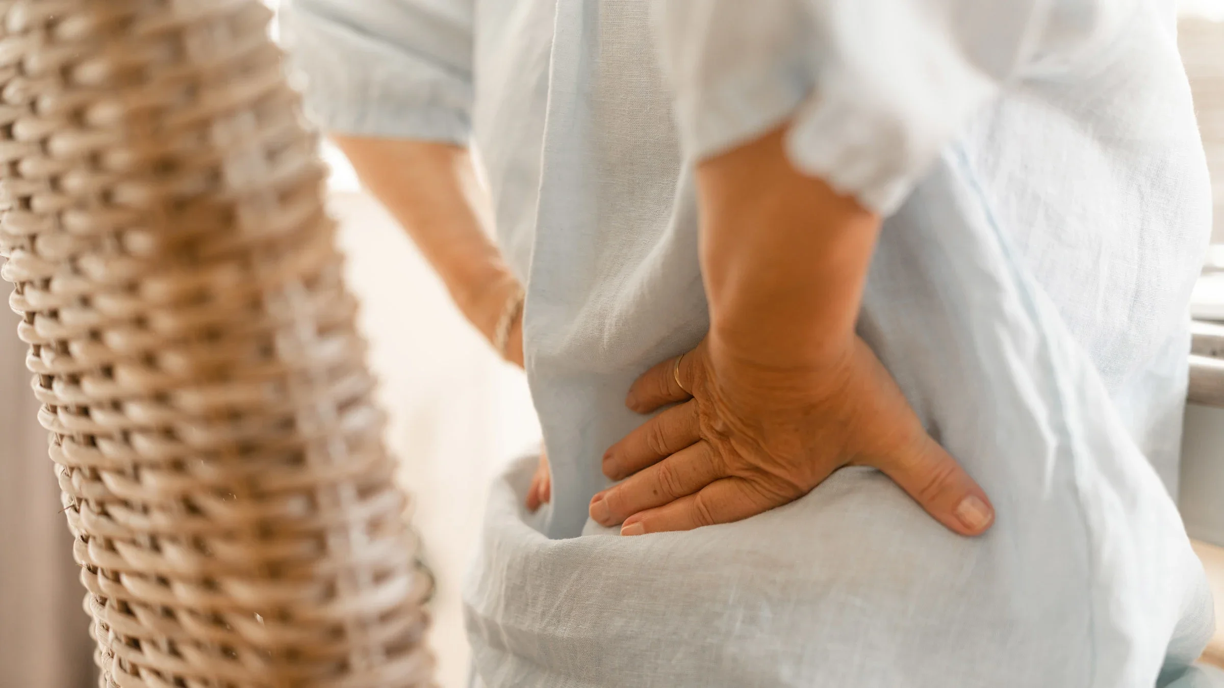 Close-up of someone rubbing their lower back in pain.
luza studios/E+ via Getty Images