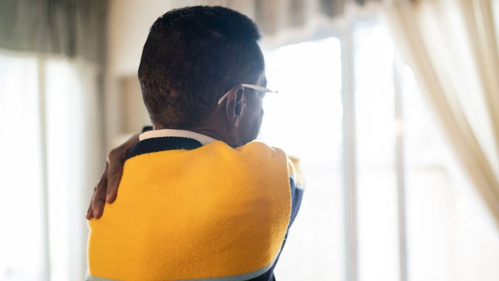 A senior man with a neck and shoulder pain injury.