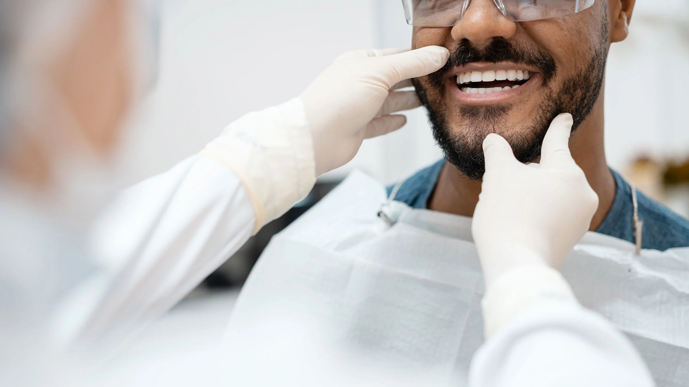 A patient is getting their teeth examined at a dentist appointment.