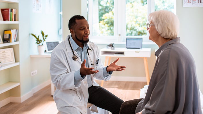 A doctor speaks to a patient during an appointment.