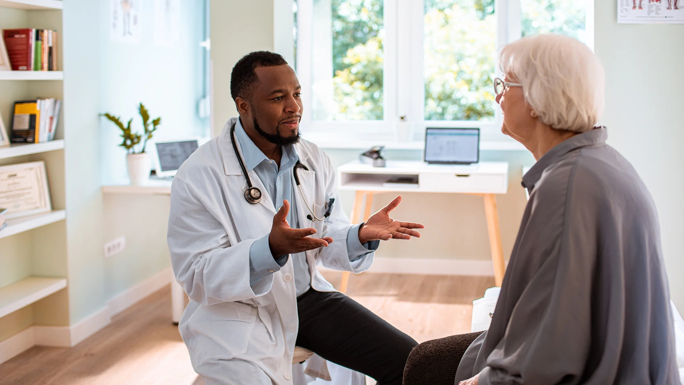 A doctor speaks to a patient during an appointment.