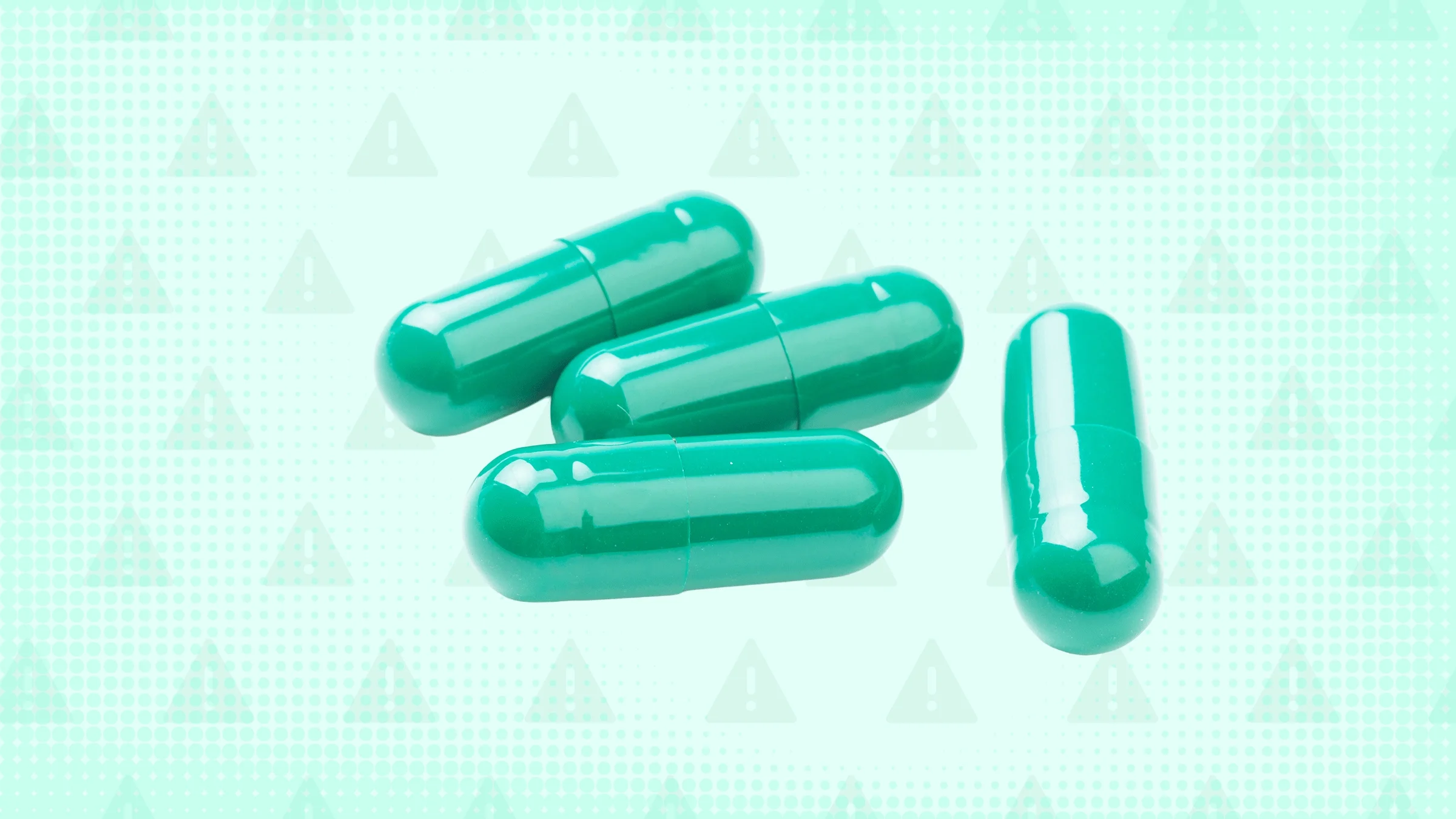 Three green capsule pills are in the center of a graphic with a light-green warning sign background.