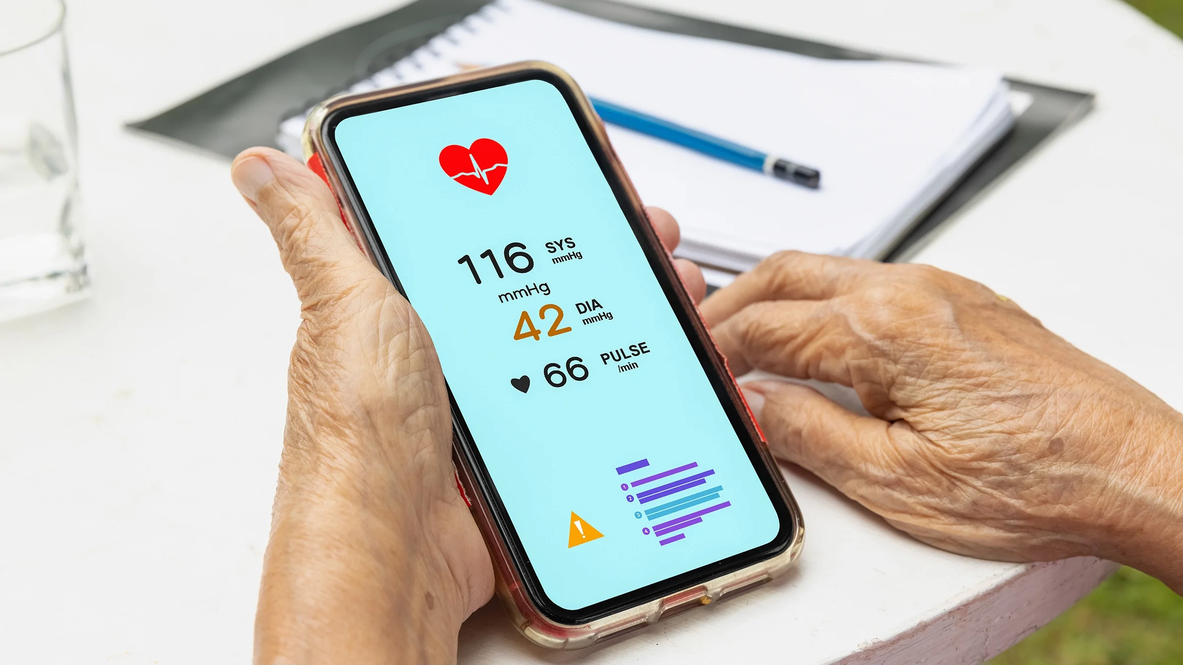 Close-up of a senior person reviewing heart health data on their smartphone.