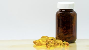 Health: icosapent-ethyl: yellow gel supplement capsules and bottle-896489076