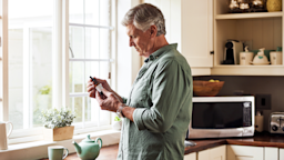A man prepares to add CBD oil to a cup of tea.
PeopleImages/iStock via Getty Images Plus