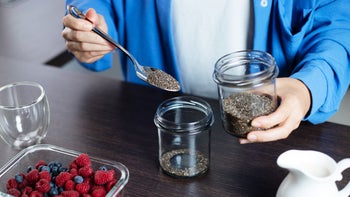 Diet and nutrition: closeup scooping chia seeds 1796255376
