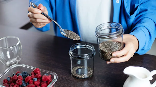 Diet and nutrition: closeup scooping chia seeds 1796255376