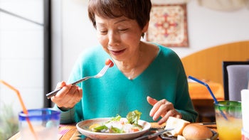 Health: Diet and nutrition: senior woman eating lunch at restaurant 1153358772