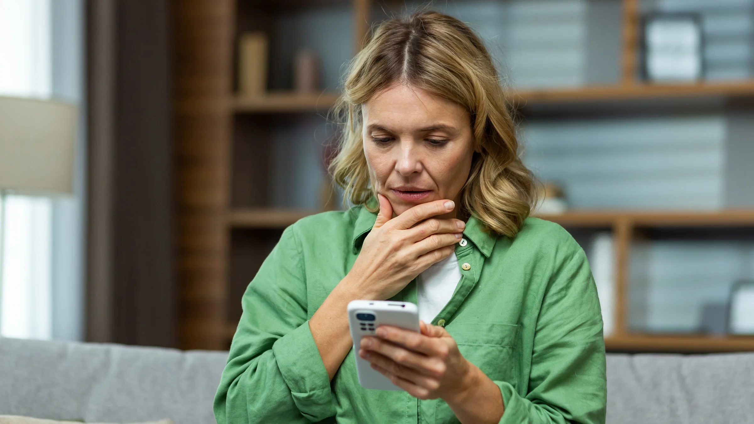 A person thinking and researching something on their phone.