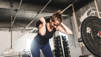 Movement-exercise: woman exercising with weight plate 1166468804