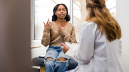A teenager speaks to a doctor during a doctor's appointment.
SDI Productions/E+ via Getty Images