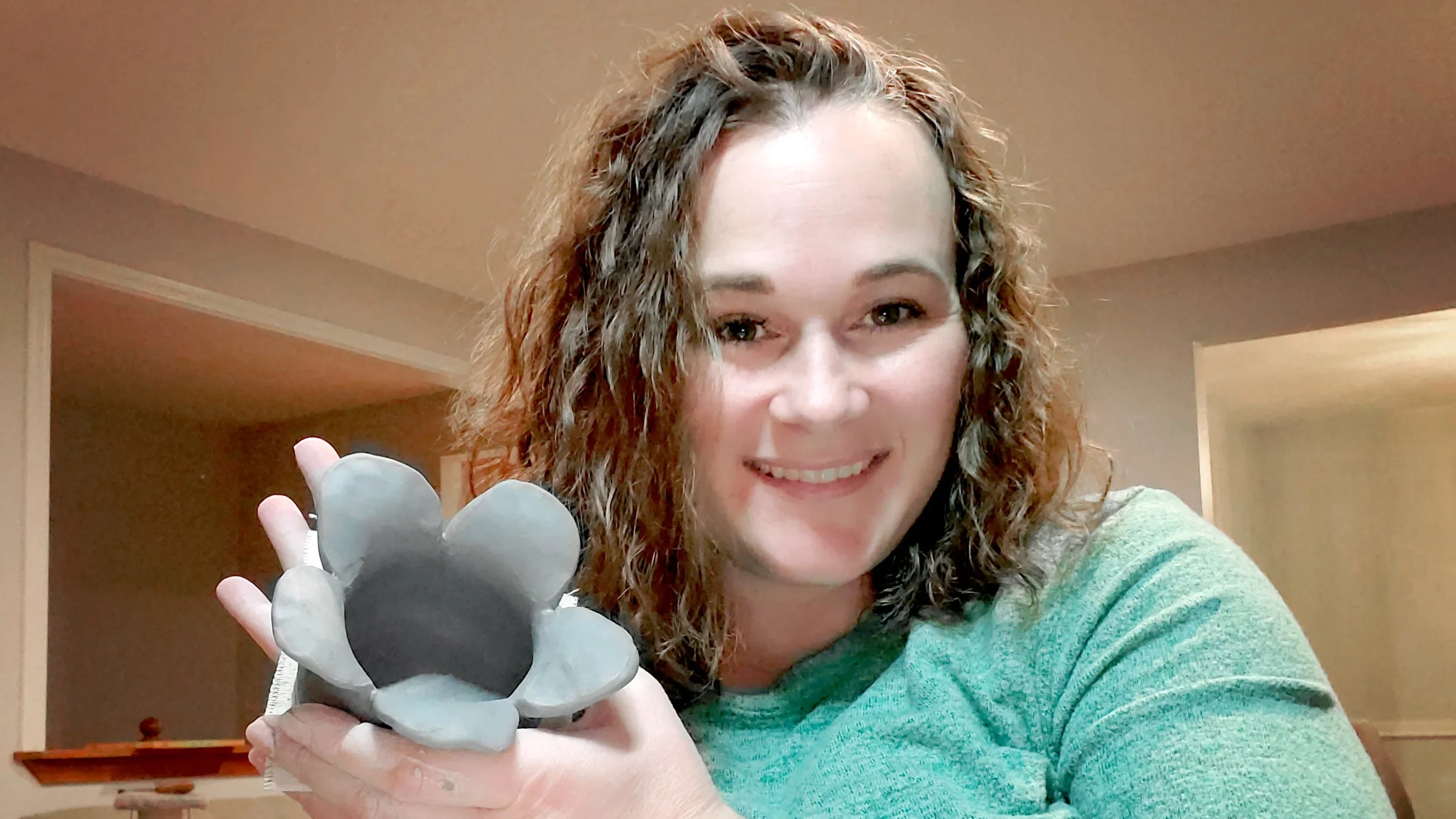 Chrissy Mitchell holding a clay flower