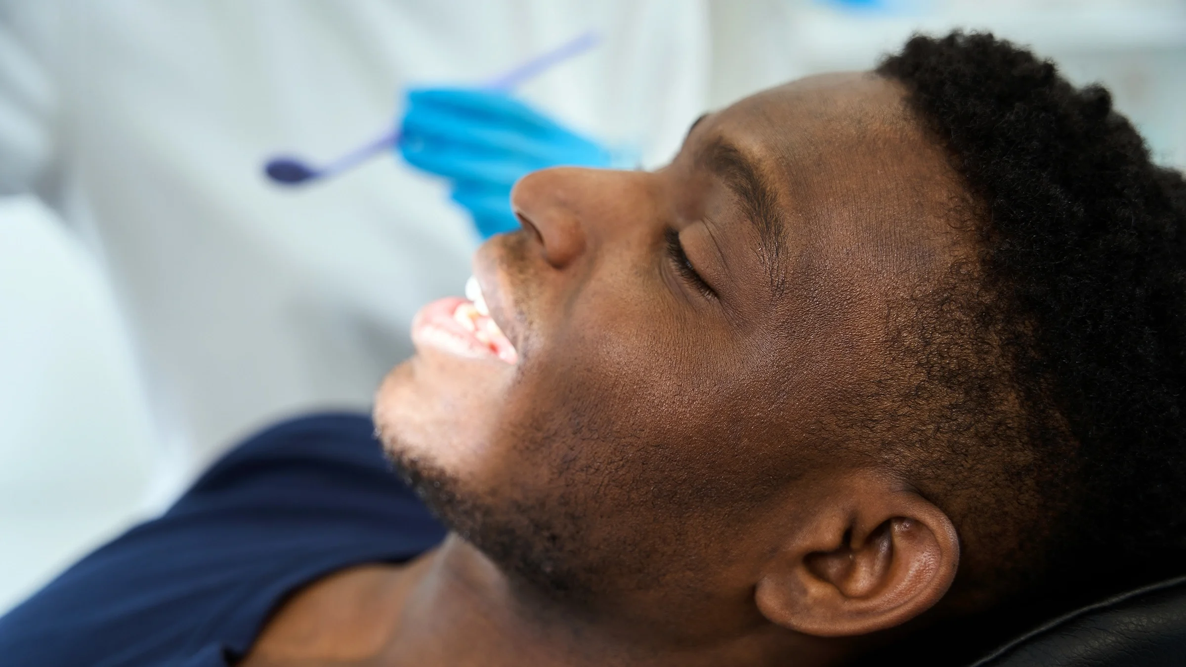 A man smiles during a visit to the dentist. Fillings and crowns are used to repair damage to the teeth. Deciding which one is better and most suitable for you depends on several factors, such as severity of tooth decay and whether there’s nerve damage.